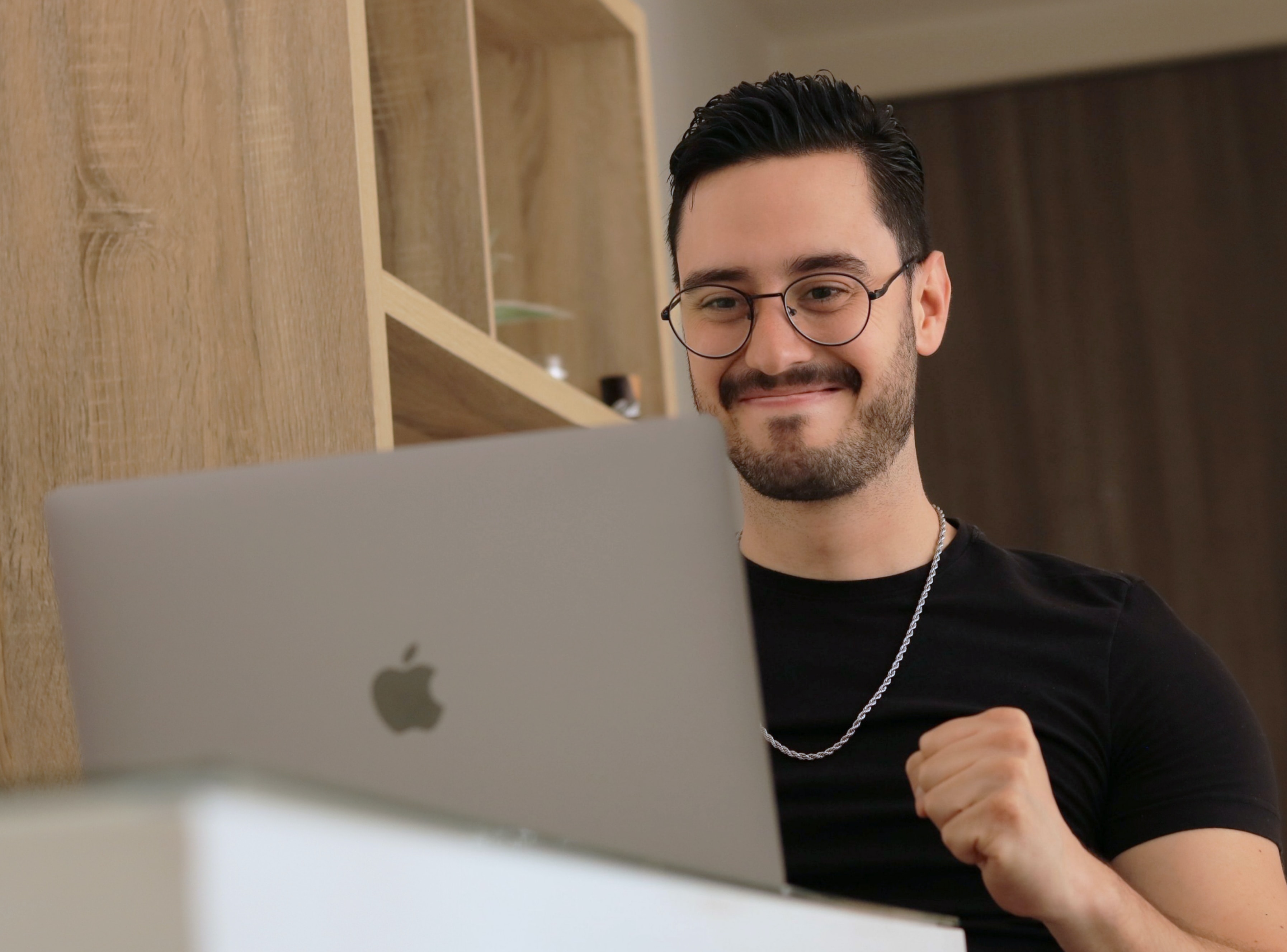 happy man looking at laptop - refinancing mortgage while in chapter 13