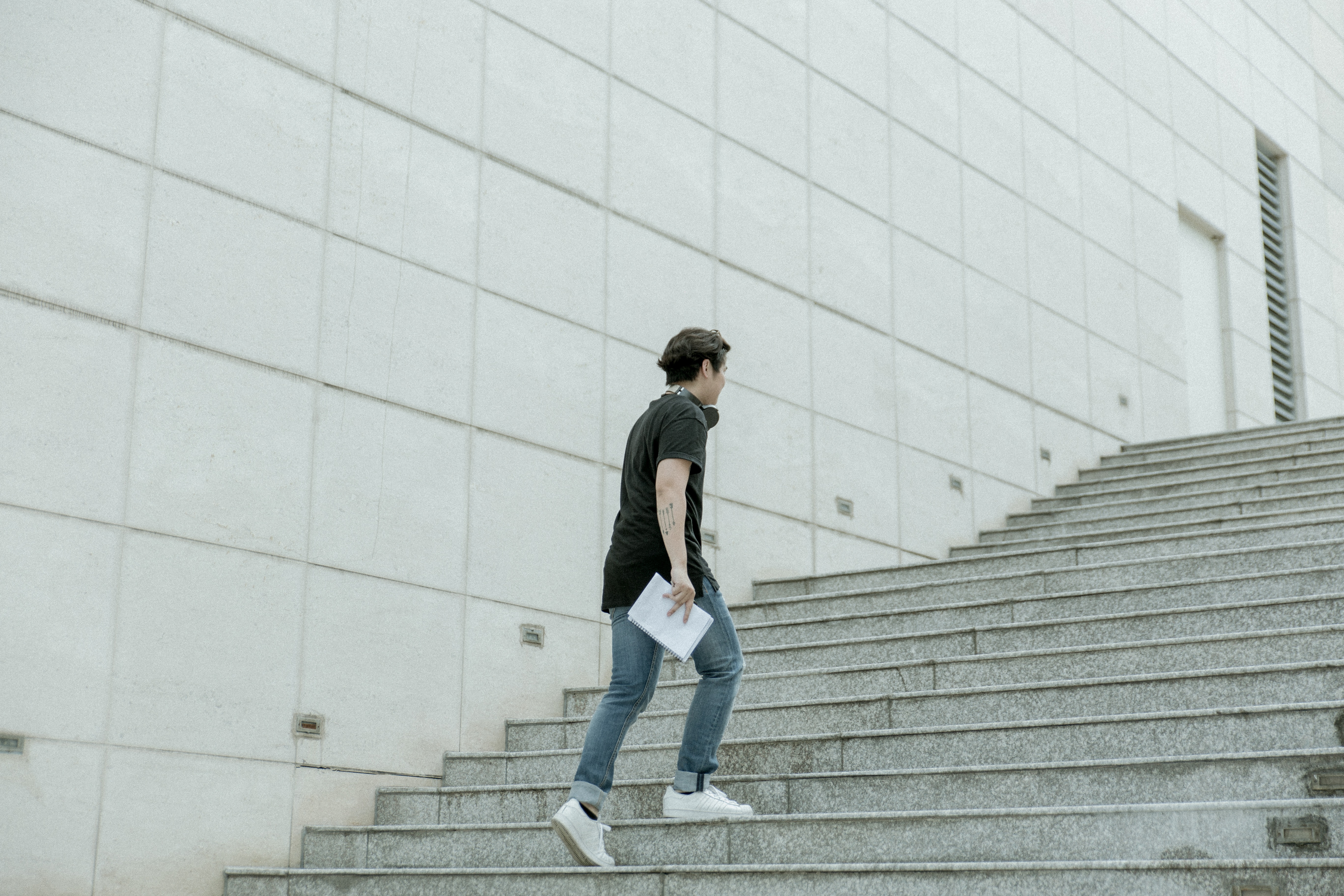 man climbing steps with documents - foreclosure refinance